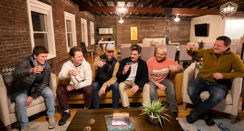 happy male friends taking selfie holding beer at bachelor party