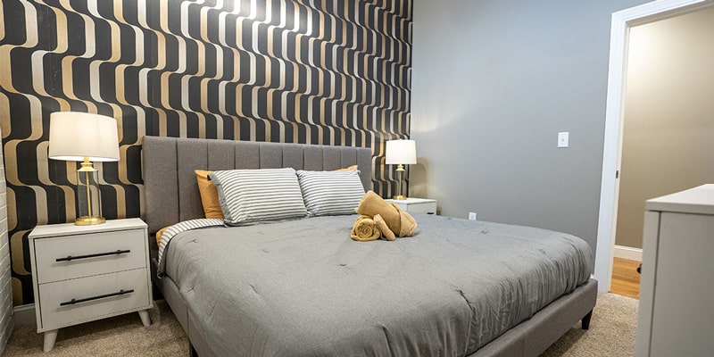 bedroom with modern black and gold pattern wall